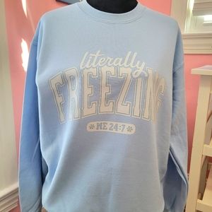 A literally freezing "DTF" printed light blur sweatshirt.